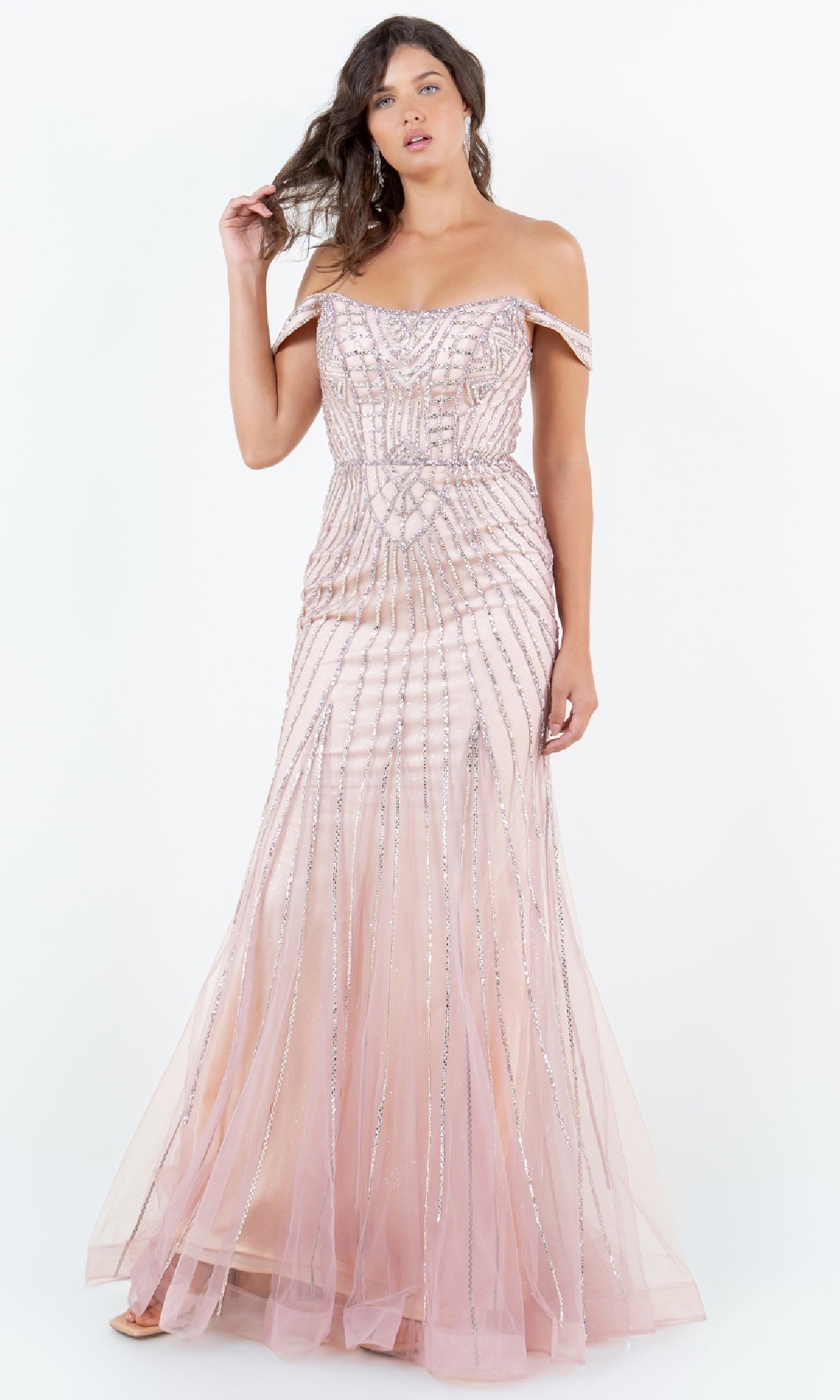 A woman models the Cinderella Couture 8271J, a floor-length, off-the-shoulder light pink prom dress with silver beaded accents, against a plain white background.